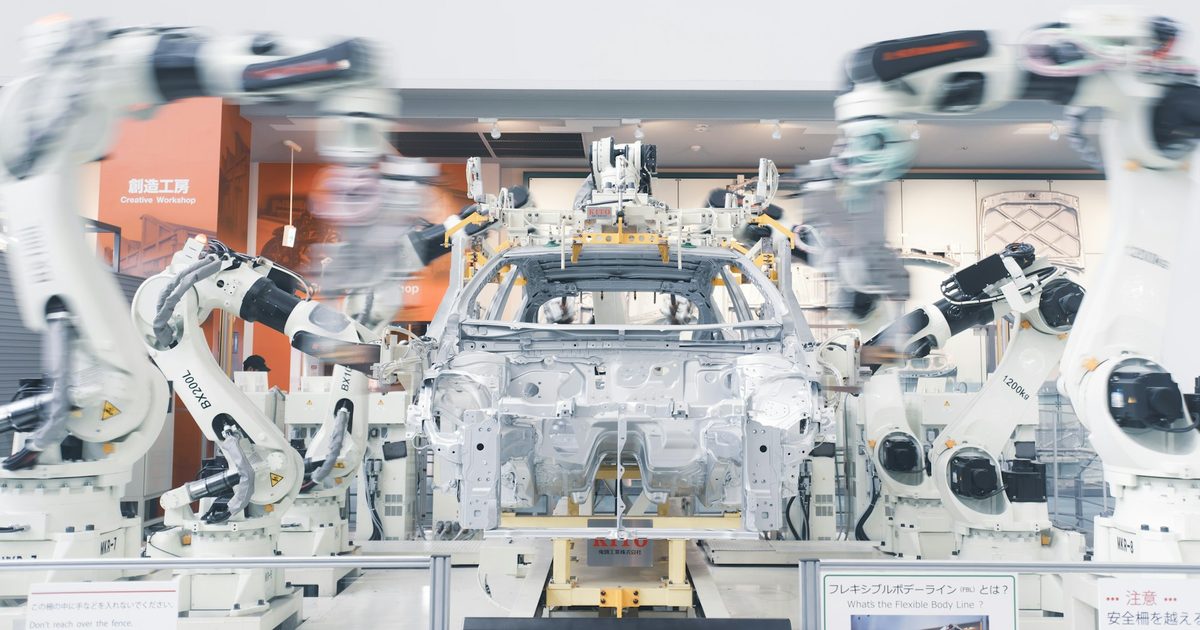 Robotic arms assembling a car body on an automated production line