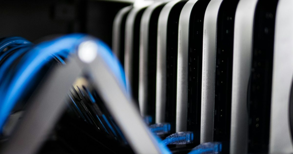 Dense network cabling running through a data centre rack